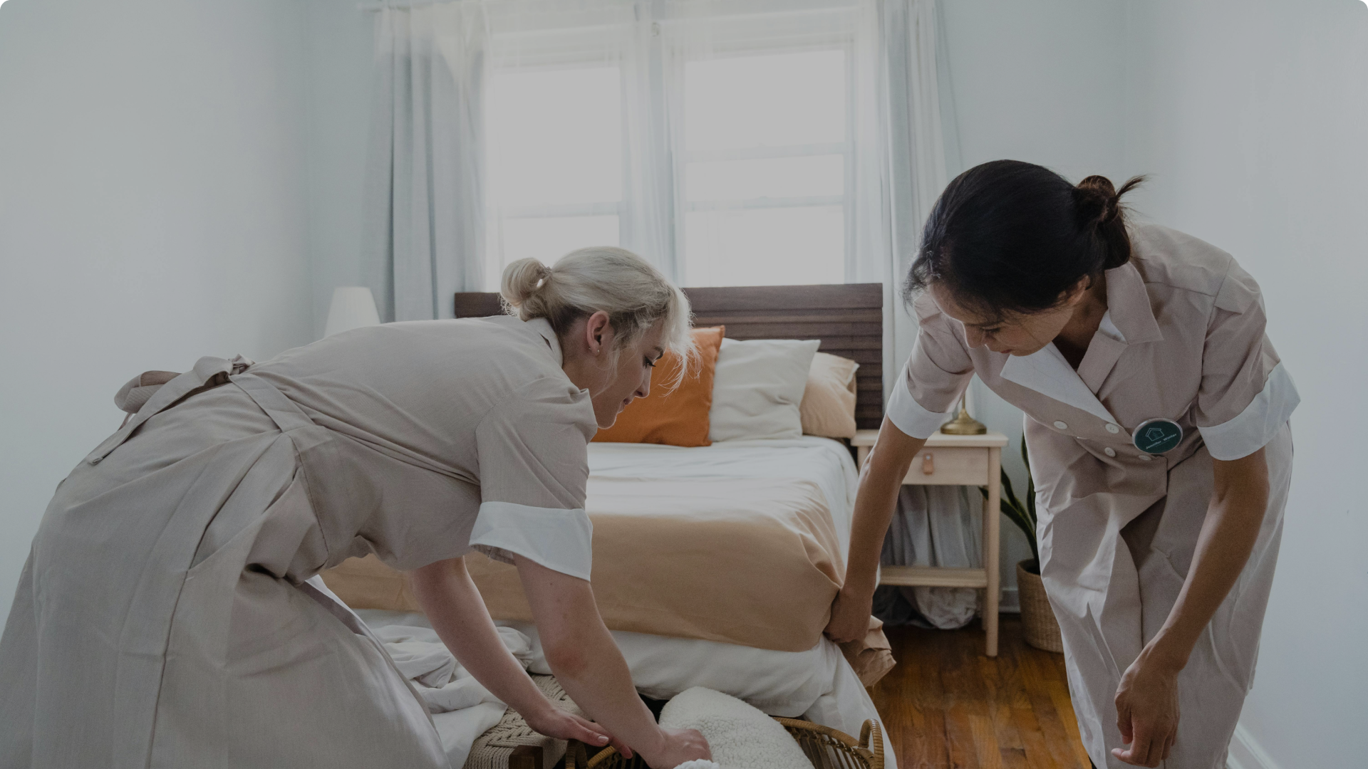 Cleaners cleaning a bedroom