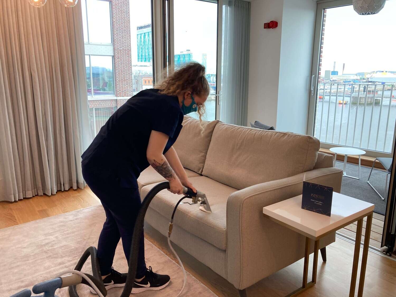 woman vacuuming the couch
