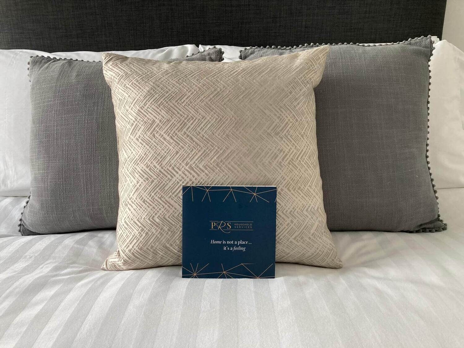 three pillows on a bed