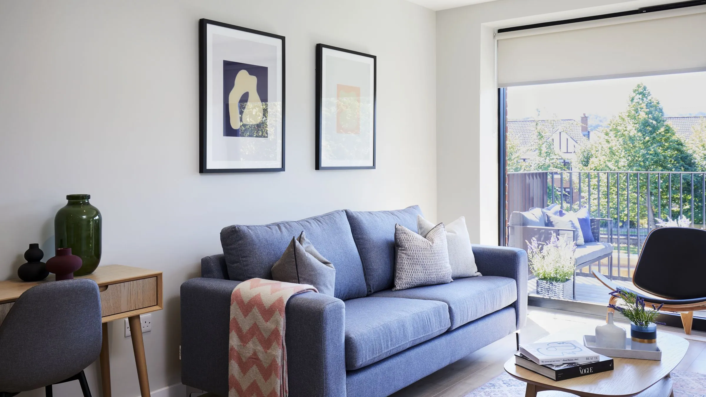 A clean living room with a blue couch