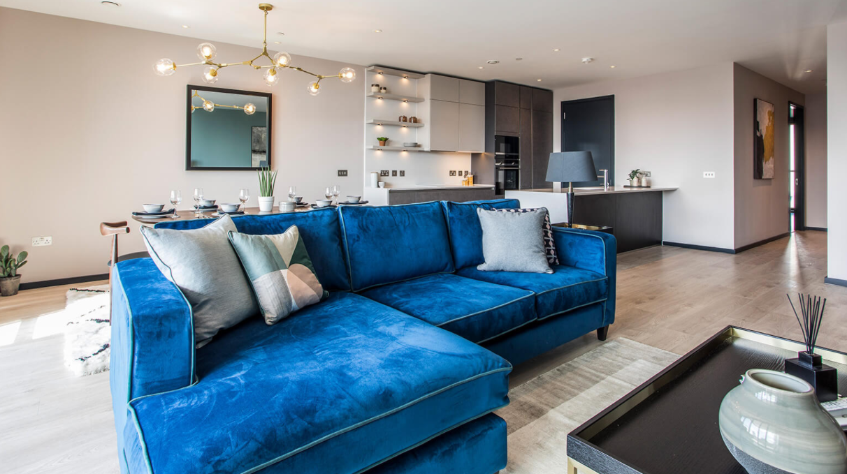 A clean living room with a blue couch