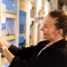 Woman smiling looking at items