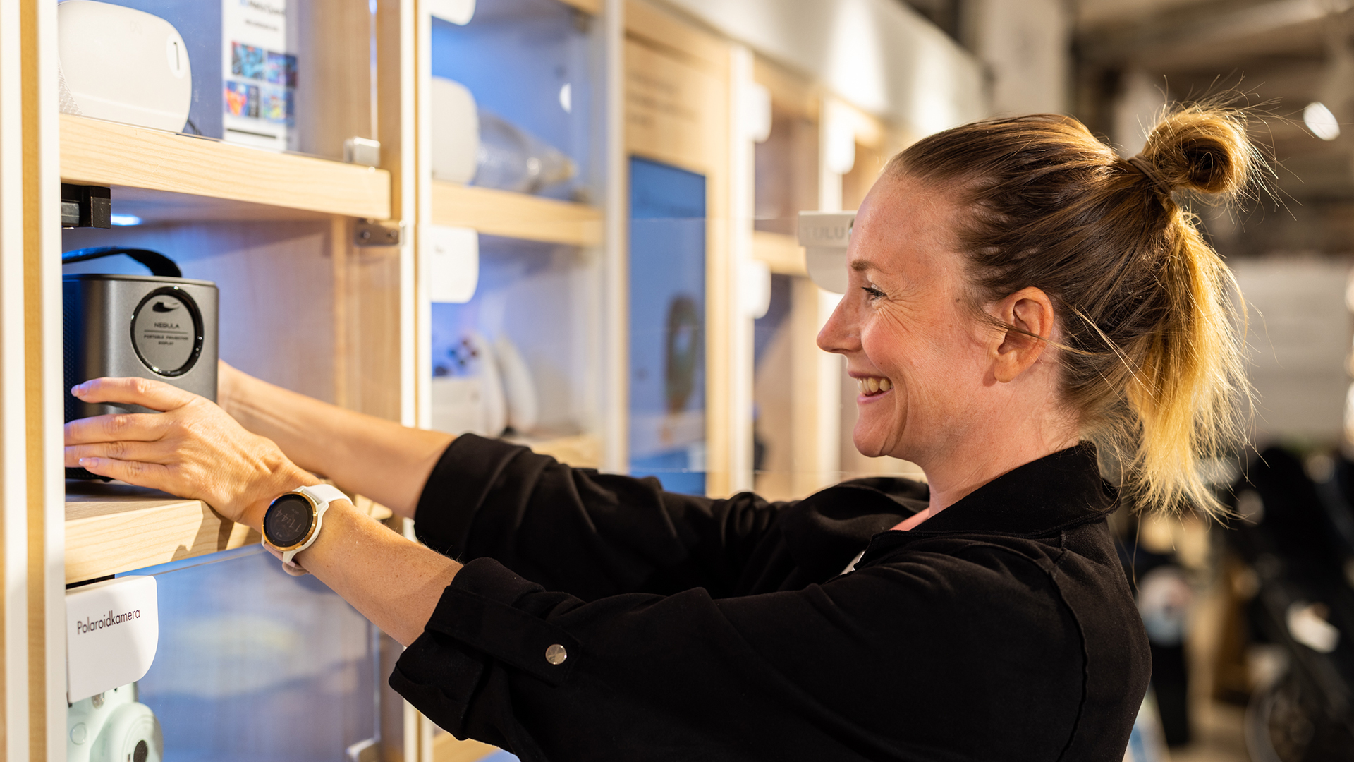 Woman smiling holding a product